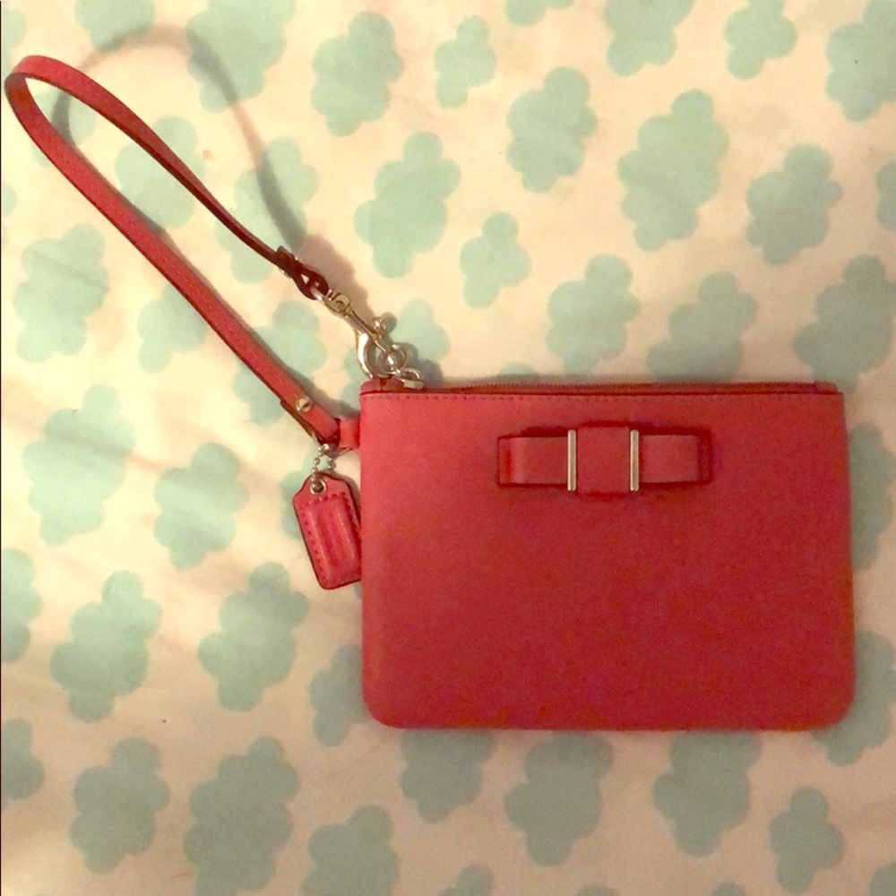 Pink coach clutch